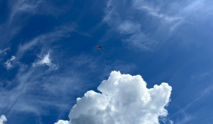 Orange Sentaero Aircraft in the sky above the clouds equipped for BVLOS drone operations