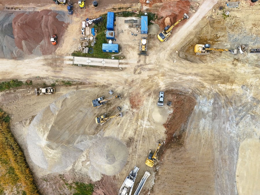 Overhead drone view of a construction site with heavy equipment